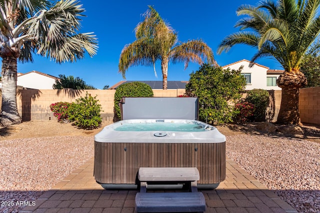 view of patio / terrace with a hot tub