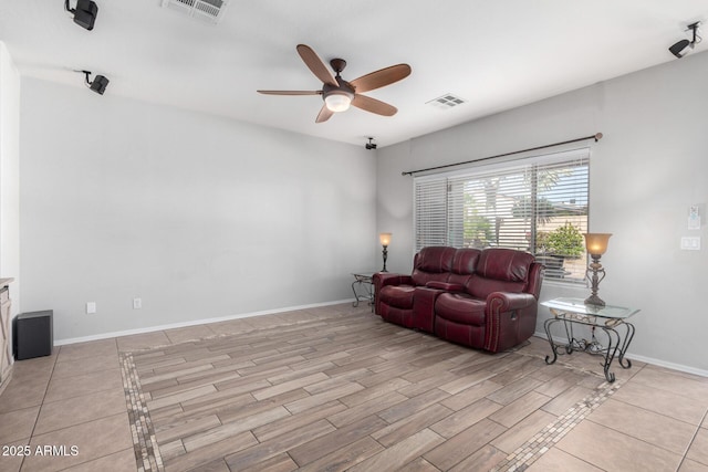 living room featuring ceiling fan and light hardwood / wood-style floors