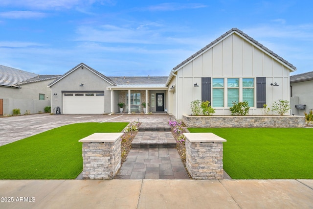 view of front of home featuring a garage, a front lawn, decorative driveway, and board and batten siding