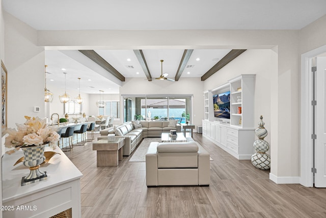 living area with a chandelier, recessed lighting, beam ceiling, and light wood-style floors