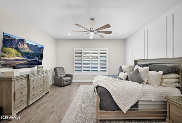 bedroom featuring a ceiling fan, recessed lighting, light wood-style flooring, and baseboards