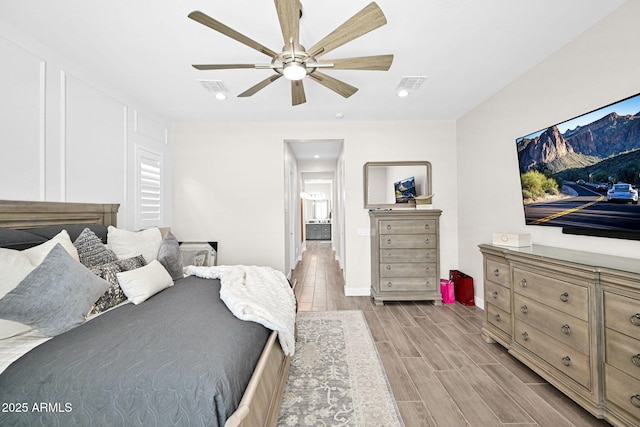 bedroom featuring wood tiled floor, visible vents, a ceiling fan, and recessed lighting