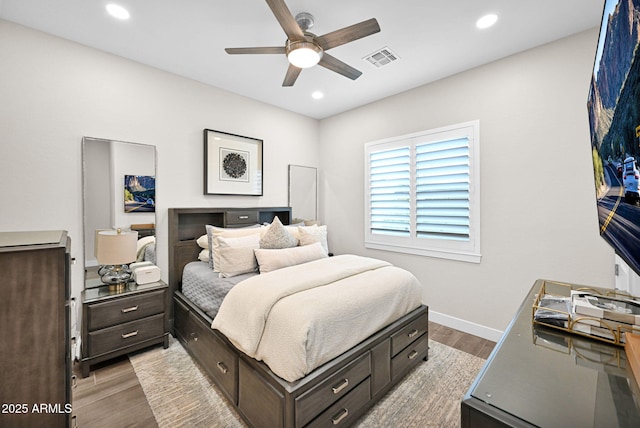 bedroom with baseboards, light wood-type flooring, visible vents, and recessed lighting