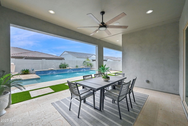 view of patio with outdoor dining space, a fenced backyard, a ceiling fan, and a fenced in pool