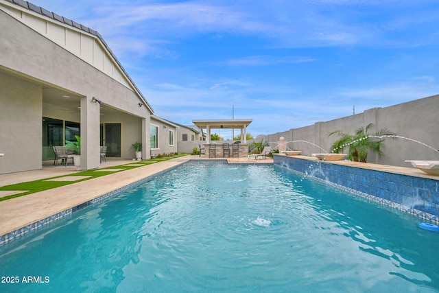 view of swimming pool with a patio area, a fenced backyard, outdoor dry bar, and a fenced in pool