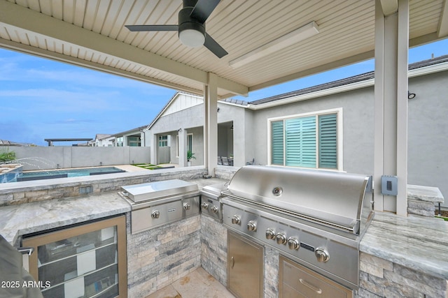 view of patio / terrace featuring ceiling fan, an outdoor kitchen, a fenced backyard, a grill, and a fenced in pool