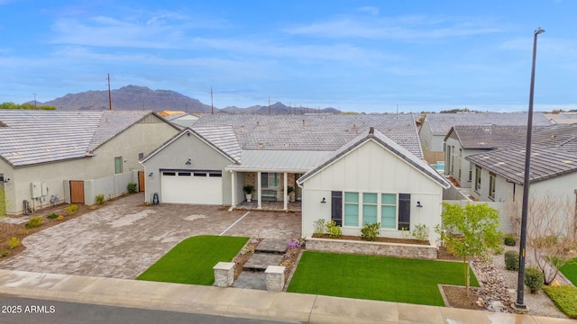 view of front facade with a garage, fence, decorative driveway, a front lawn, and board and batten siding