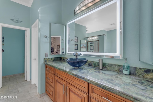 bathroom with crown molding, vanity, and tile patterned flooring