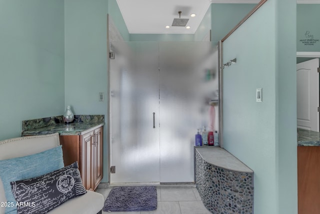 bathroom with walk in shower, tile patterned floors, and vanity