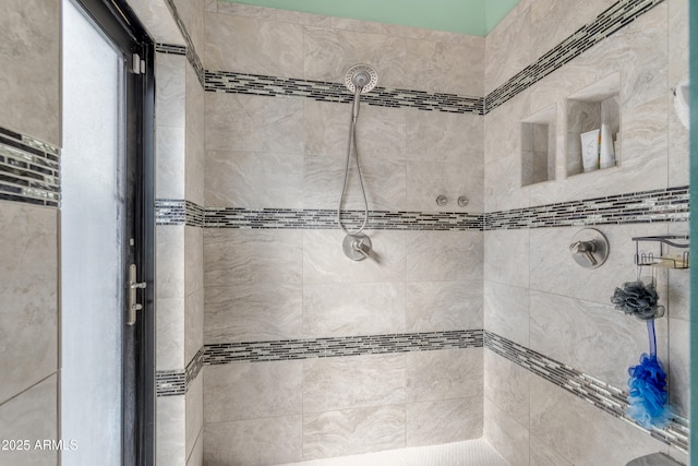 bathroom with a tile shower