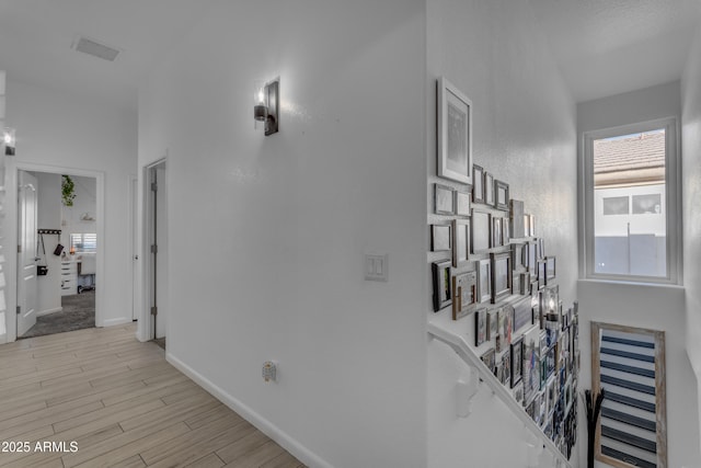 hallway with light hardwood / wood-style flooring