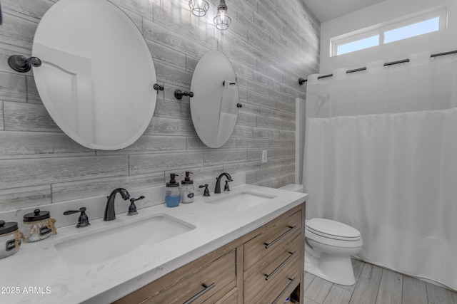 bathroom with a shower with curtain, tile walls, vanity, decorative backsplash, and toilet