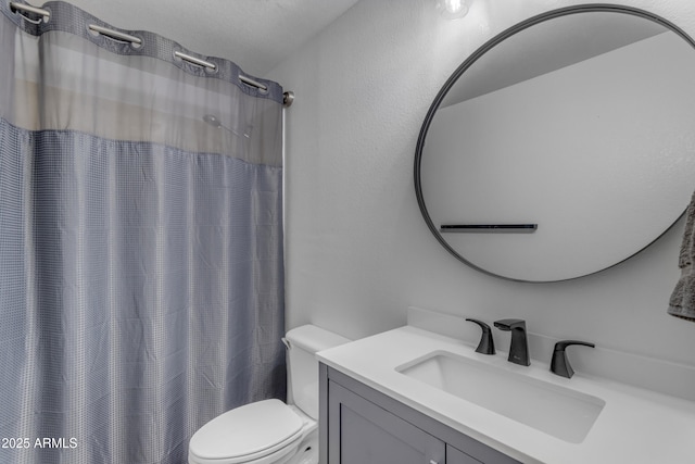 bathroom featuring vanity, curtained shower, and toilet