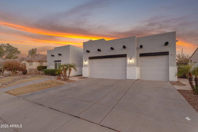 pueblo-style home featuring a garage