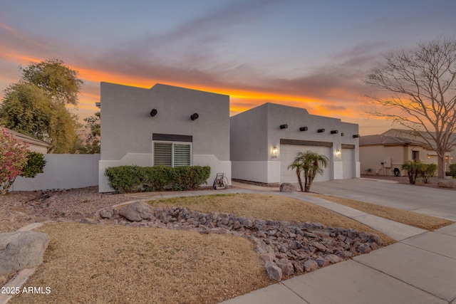 pueblo revival-style home with a garage