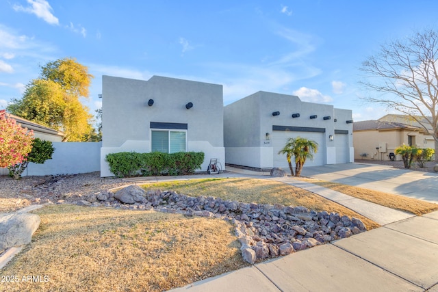 pueblo-style house with a garage