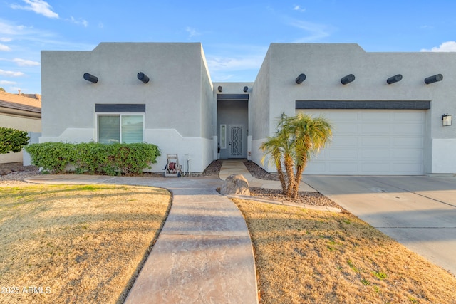 southwest-style home featuring a garage and a front lawn