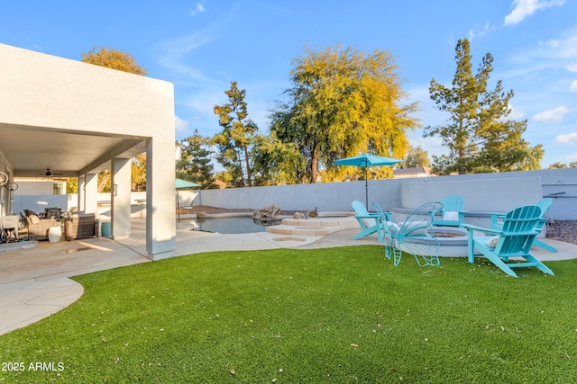 view of yard featuring ceiling fan and a patio area