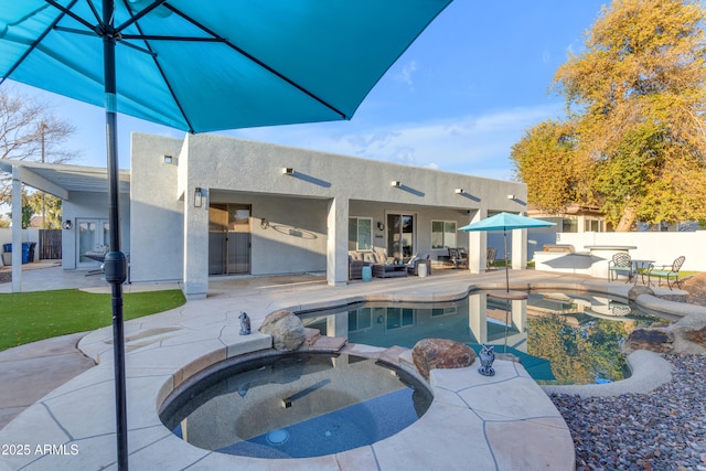 view of pool with an in ground hot tub, outdoor lounge area, and a patio