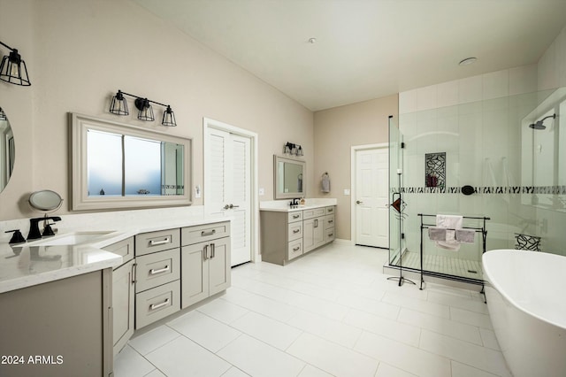 bathroom with tile patterned flooring, vanity, and independent shower and bath