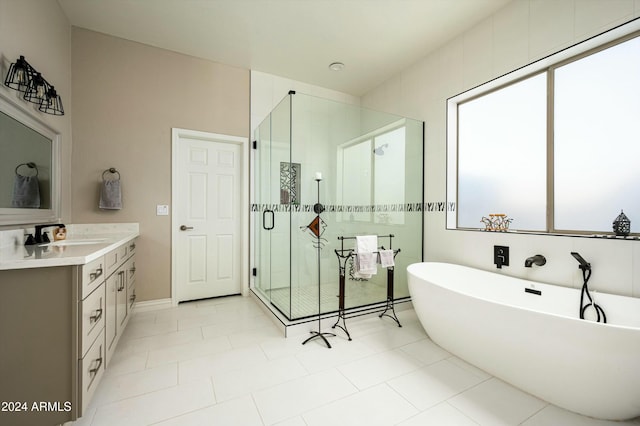 bathroom featuring separate shower and tub, a wealth of natural light, tile patterned flooring, and vanity