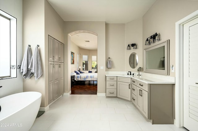 bathroom featuring hardwood / wood-style flooring, vanity, and a tub