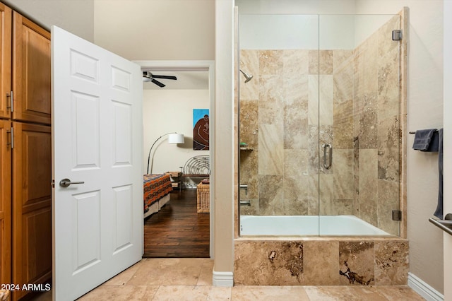 bathroom with ceiling fan, wood-type flooring, and enclosed tub / shower combo