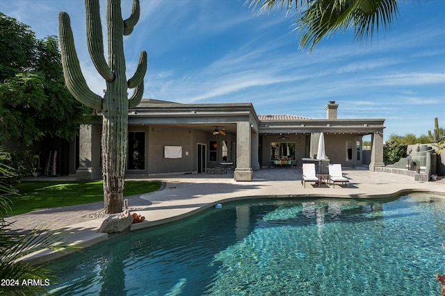 back of property with a patio area and ceiling fan