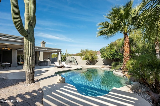 view of swimming pool featuring a patio and ceiling fan