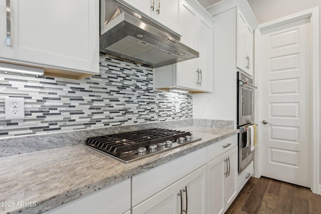 11872 W Duane Ln, Peoria, AZ 85383 - kitchen with under cabinet range hood, appliances with stainless steel finishes, dark wood-type flooring, white cabinets, and backsplash