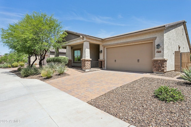 11872 W Duane Ln, Peoria, AZ 85383 - view of front of property with stone siding, stucco siding, a garage, and driveway