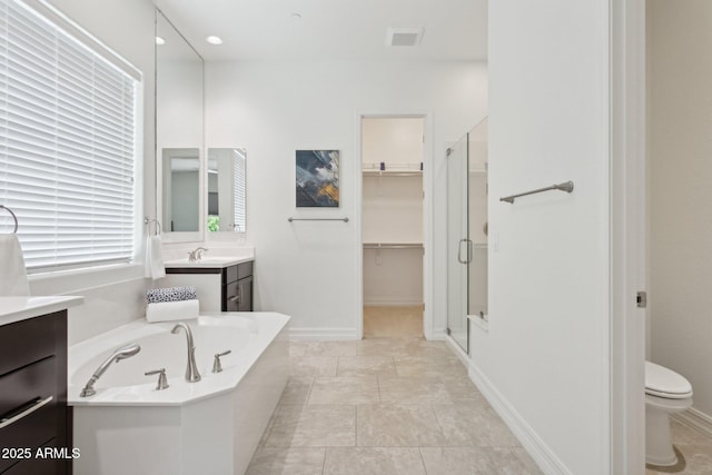 11872 W Duane Ln, Peoria, AZ 85383 - full bath featuring vanity, a shower stall, a garden tub, toilet, and baseboards