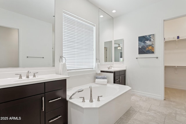 11872 W Duane Ln, Peoria, AZ 85383 - full bathroom with vanity, a garden tub, a ceiling fan, a walk in closet, and baseboards