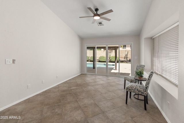 living area with visible vents, tile patterned flooring, baseboards, ceiling fan, and vaulted ceiling