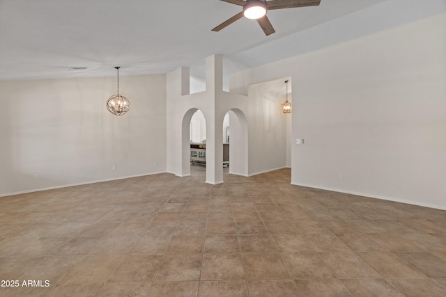 unfurnished living room featuring visible vents, arched walkways, baseboards, and ceiling fan with notable chandelier