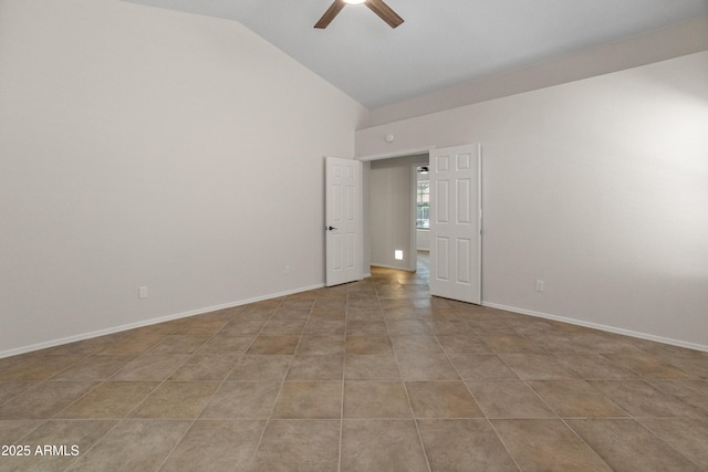 tiled empty room featuring baseboards, a ceiling fan, and vaulted ceiling