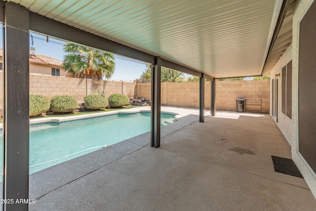 view of swimming pool featuring a fenced in pool, a fenced backyard, and a patio area