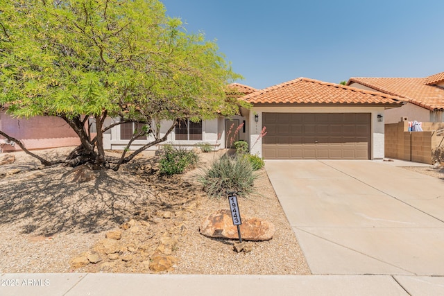 view of front of house featuring a garage, stucco siding, driveway, and a tiled roof