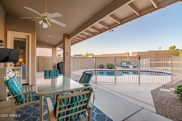 view of patio / terrace featuring a fenced in pool, a fenced backyard, ceiling fan, and outdoor dining area