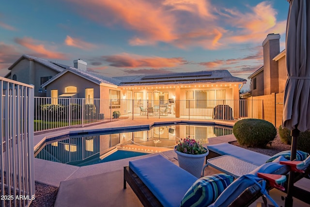 view of swimming pool featuring a fenced in pool, a patio area, and fence