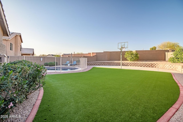 view of yard with a fenced in pool and a fenced backyard