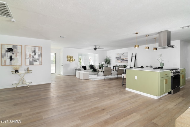 kitchen featuring range with electric cooktop, a kitchen breakfast bar, hanging light fixtures, light hardwood / wood-style floors, and range hood