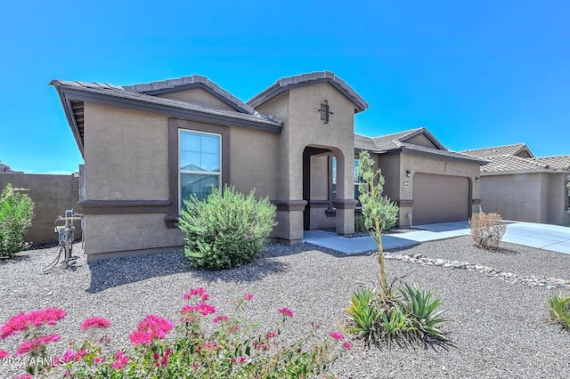 view of front of home featuring stucco siding, driveway, and an attached garage