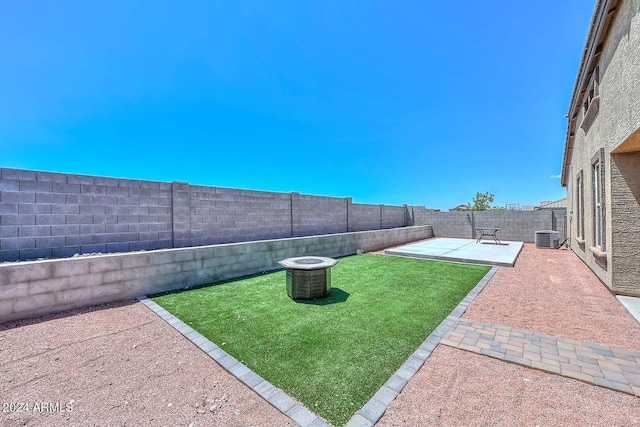 view of yard featuring a patio, central AC, and a fenced backyard