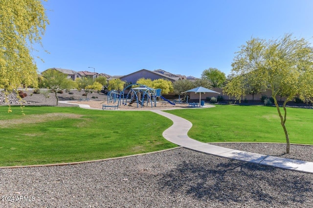 surrounding community featuring playground community and a yard