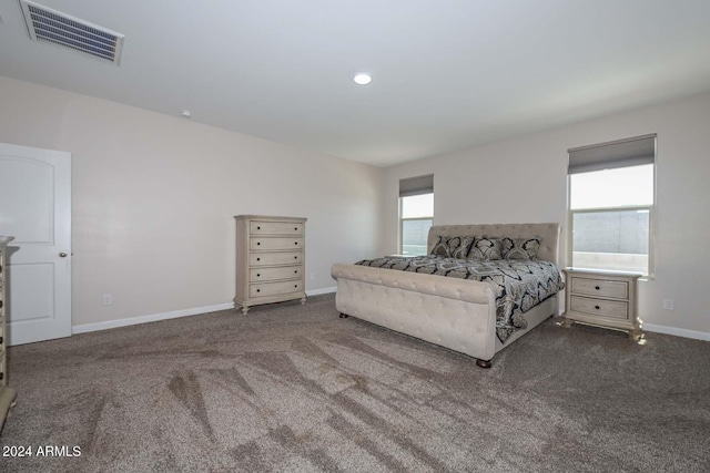 carpeted bedroom with baseboards and visible vents