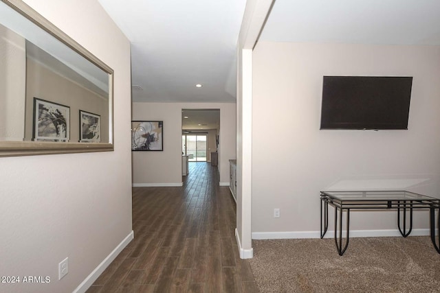 corridor featuring recessed lighting, wood finished floors, and baseboards