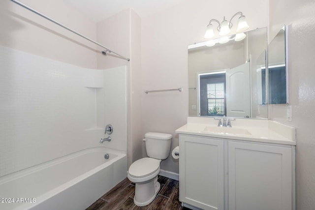 bathroom with toilet, wood tiled floor, baseboards, bathing tub / shower combination, and vanity