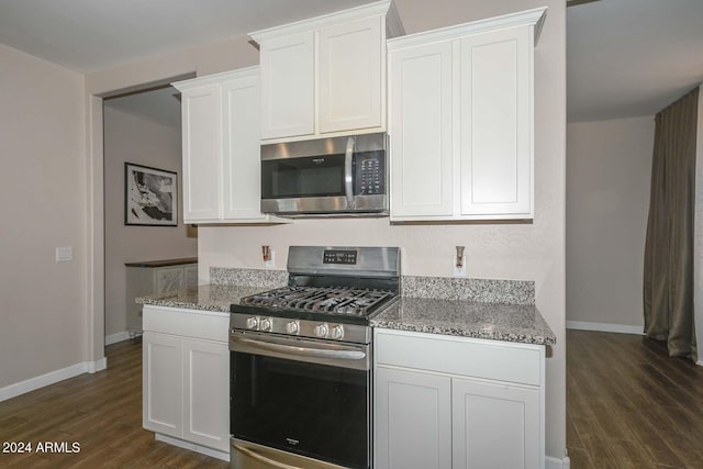 kitchen with white cabinetry, light stone countertops, stainless steel appliances, and dark wood-style flooring