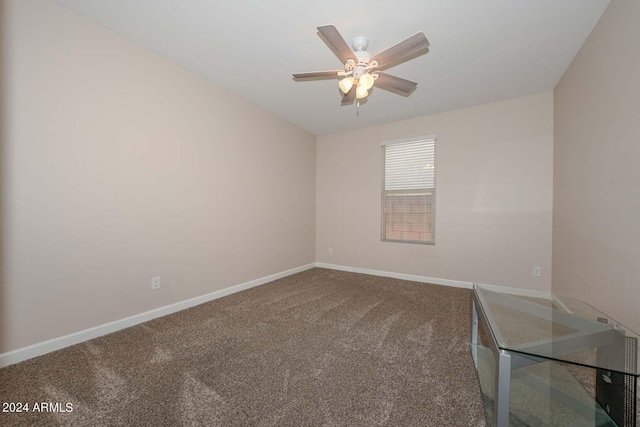 empty room with baseboards, carpet, and ceiling fan